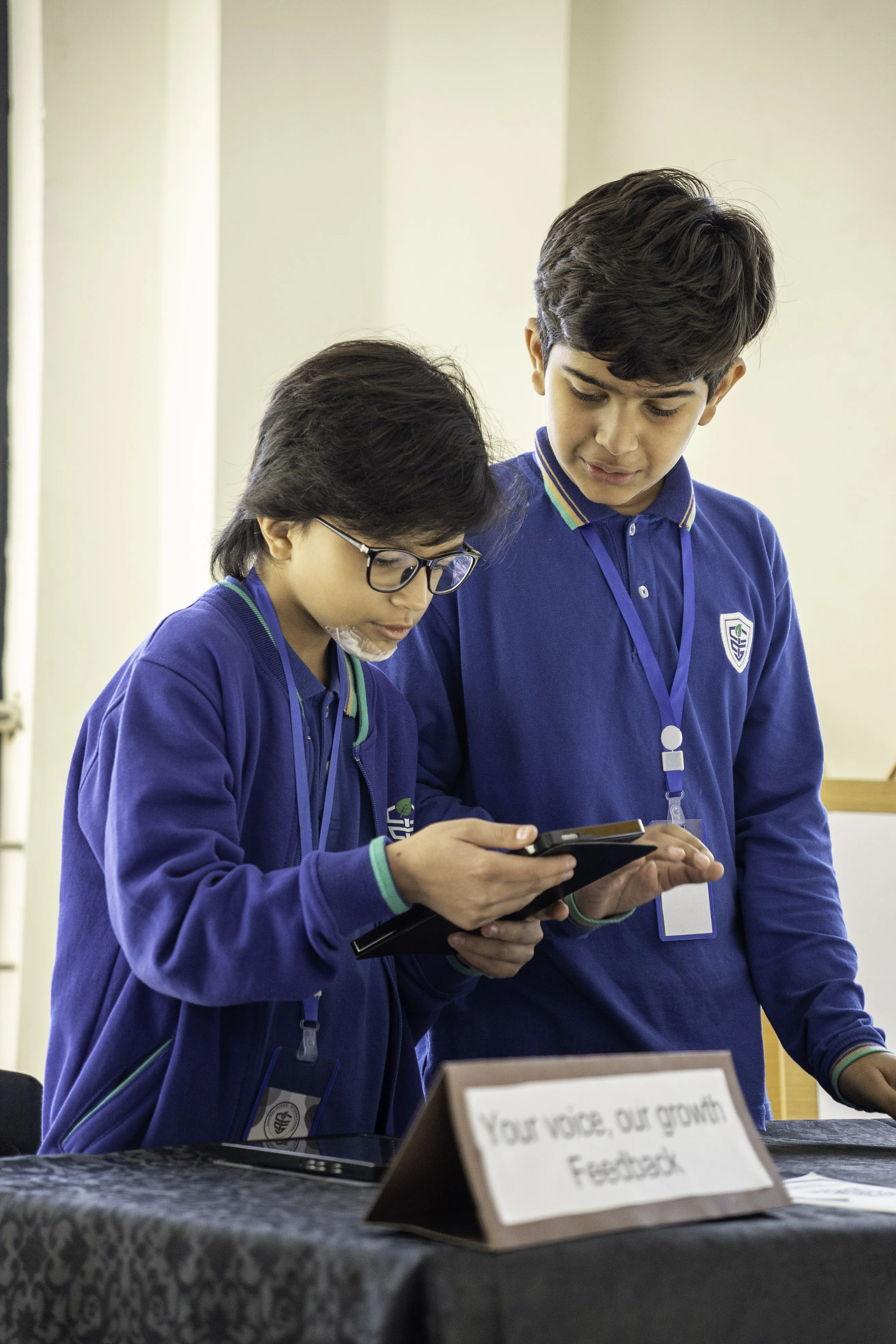 CSI students using a tablet while reviewing evidence from their learning